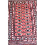 Tekke pattern rug, red ground, stylised border, 170 x 95cms.