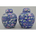 Pair of Chinese export ginger jars and covers, with a floral decoration on a blue ground,
