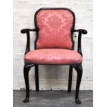 French walnut armchair, with salmon stylised upholstery.