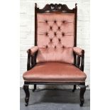 Oak framed grandfather chair, salmon button-back upholstery, cabriole legs.
