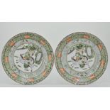 Pair of Chinese Famille Verte chargers, decorated with oriental hunting scenes,