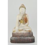 Carved marble figure of a seated Buddha, with jewelled decoration on a plinth base.
