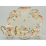 French porcelain part cabaret set, peach and floral decoration, comprising of a teapot, milk jug,