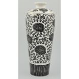 Chinese tall vase, decorated with a black stylised flower decoration on a white ground,