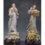 Pair of Sitzendorf style porcelain figures of maidens, encrusted with flowers, 34cm.