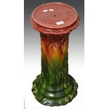 Pottery jardiniere stand, Bretby style moulded and spiral fluted, red to ochre to green glaze, 64cm.