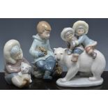 Lladro group of two Inuit children, on a Polar bear, 18cm,