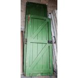 Four large painted and slatted pine doors, approximately 287cm x 91cm and two similar smaller doors,