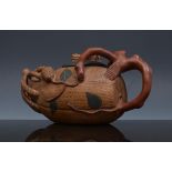 Chinese Yixing teapot, in the form of a growing gourd, impressed marks, length 19cm.