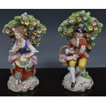 Pair of Continental porcelain Bocage figures of a young gentleman with a basket of flowers and a