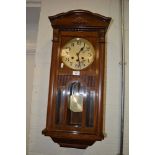 Stained walnut wall clock, silvered dial  behind a part glazed door, striking on six gongs,