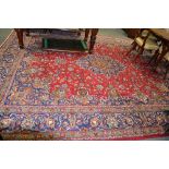 Tabriz pattern carpet, central medallion on a patterned red field, the border within guards,