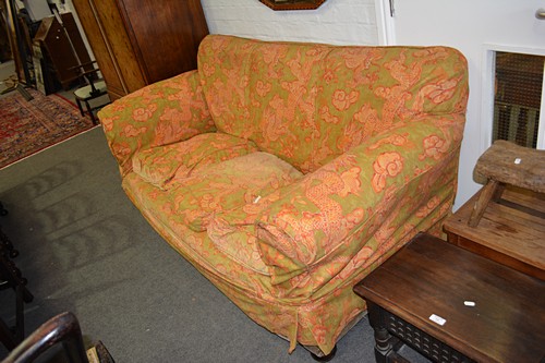 Traditional three-seater settee, cotton print loose covers, length 190cms.