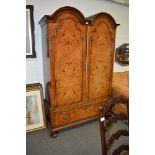 Dutch style figured walnut double dome-top armoire, the doors with quartered panels,
