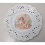 Sitzendorf porcelain dessert dish, plated and encrusted, the bowl supported by four cherubs, 22cms,