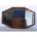 Octagonal wall mirror, beveled plate, the frame with parquetry work decoration, 55 x 90cms.