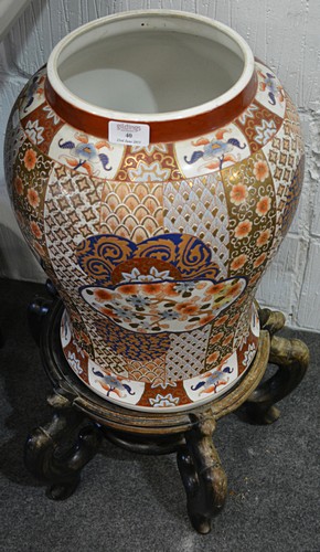 Chinese porcelain baluster shaped vase, domed lid, floral decoration, on a wooden stand, 69cm.