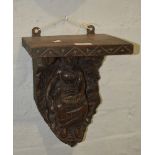 Victorian carved oak and pine wall bracket, designed with a Dutch Lady, 30cm.