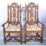 Pair of Continental carved oak high-back elbow chairs, scrolled crestings, turned uprights,