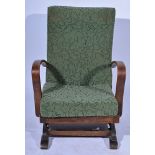 1930's beechwood framed rocking chair, upholstered in patterned uncut moquette, width 63cms.