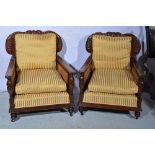 Pair of walnut deep easy chairs, carved crestings, cane panelled backs and arms,