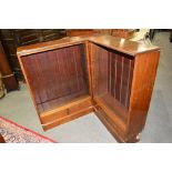 Mahogany corner bookcase, two banks of open shelves, each section with two drawers under,