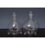 Two Victorian glass fly traps, matched stoppers, 22 and 21cms.
