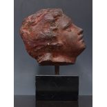 After the Antique, a terracotta coloured head fragment, set on a square plinth, 22cm overall.