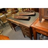 Stained wood twin pedestal desk, with an inset writing service,