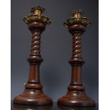 Pair of turned walnut and brass mounted candlesticks, spiral twist columns, 38cms.