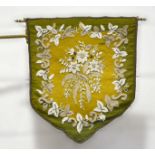 A Victorian bead and woolwork banner fire screen, 47cm x 41cm on a gilt metal bracket,