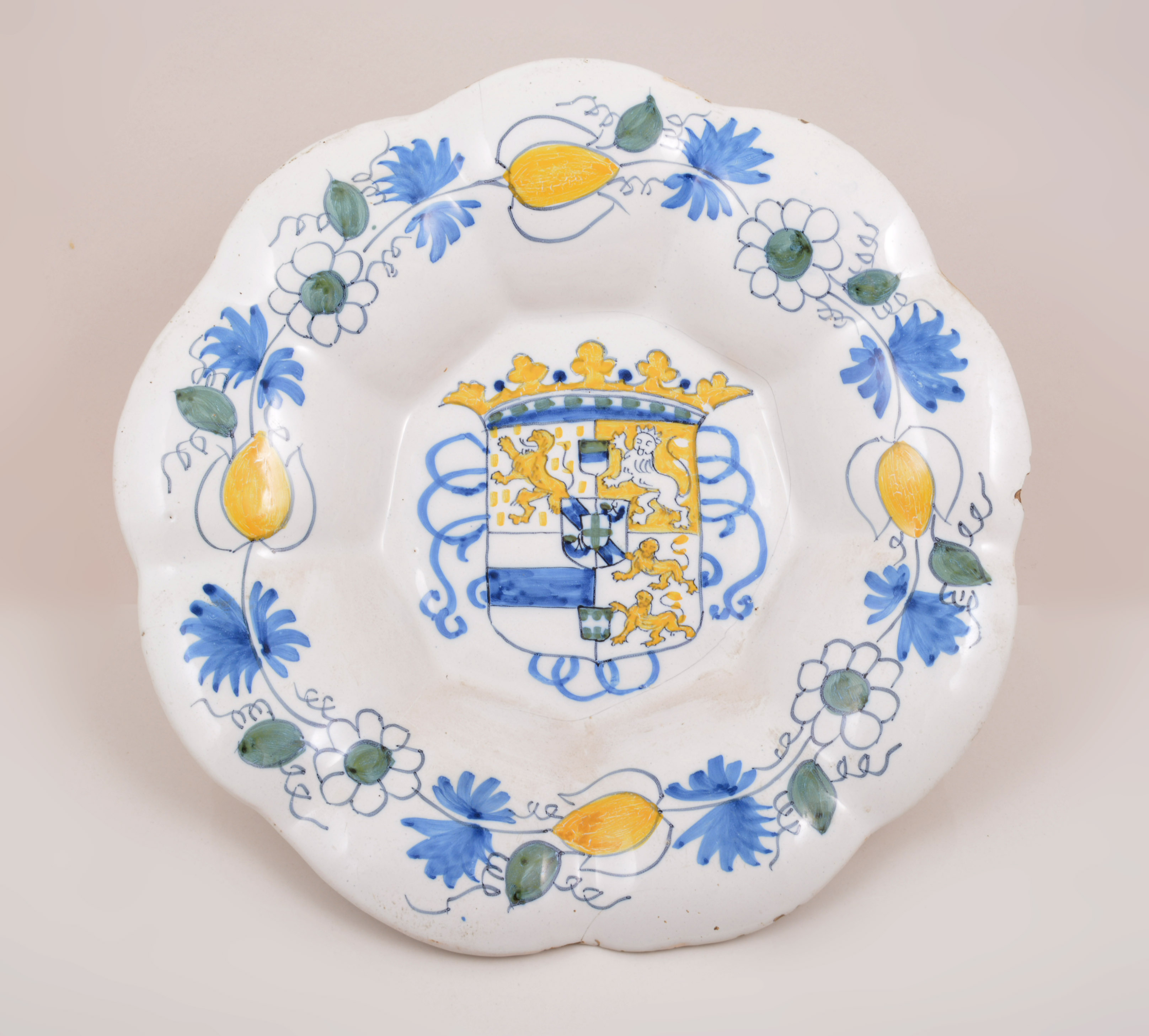 A Dutch Delft armorial shallow dish, 18th Century, lobed outline,