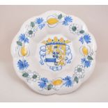 A Dutch Delft armorial shallow dish, 18th Century, lobed outline,