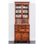 A Regency style mahogany bookcase cabinet, of small proportions, dentil cornice, plain frieze,