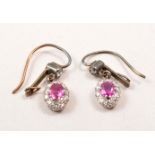 A pair of ruby and diamond oval cluster drop ear-rings,