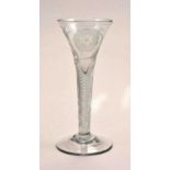 A Jacobite style wine glass, drawn trumpet bowl, with a rose and two buds,