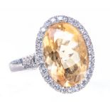 A citrine and diamond oval cluster dress ring, the mixed cut citrine 18mms x 14mms,