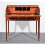 A William IV mahogany tambour front desk, enclosing a fitted interior with seven drawers,