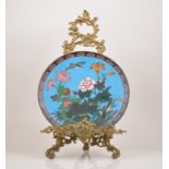 A Chinese cloisonne cerulean ground circular plaque, decorated with a kingfisher and flowers,