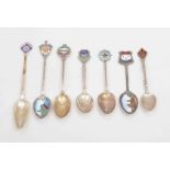 A collection of Edwardian and later silver and enamel souvenir spoons.