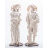 A pair of Continental carved ivory figures, of a lady and gentleman in 16th Century dress,