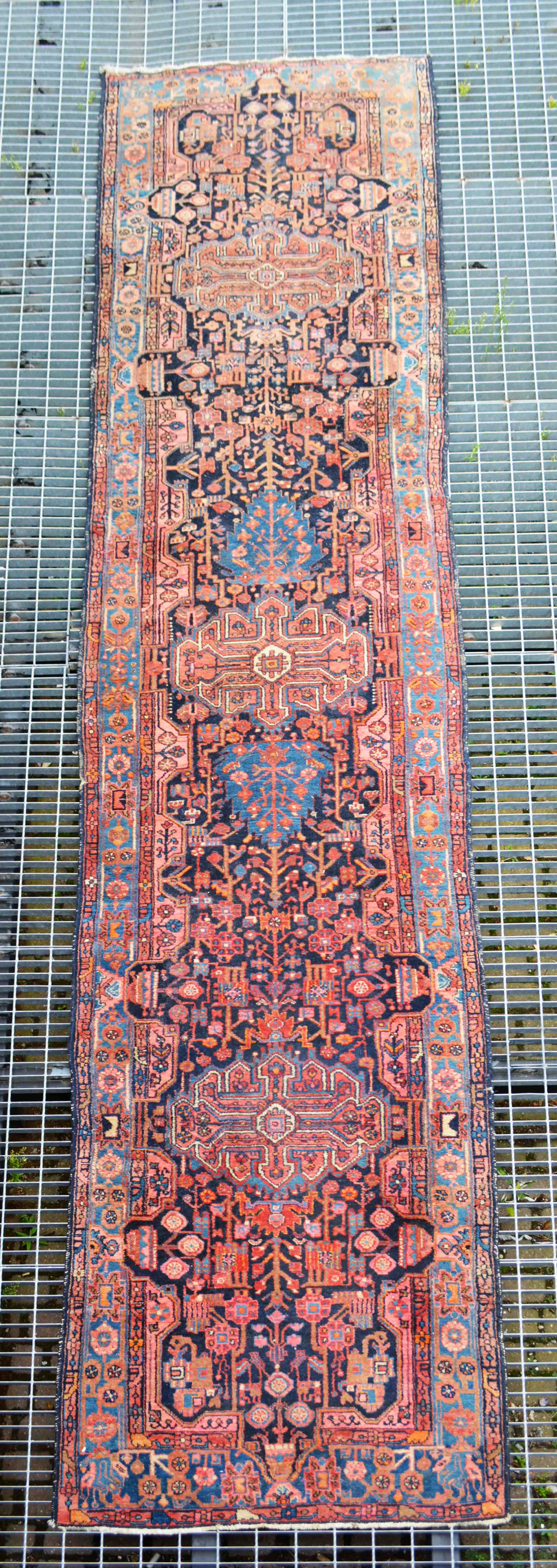 Persian runner, dark blue ground with three medallions and stylised flowers,