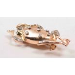 A yellow metal leaping frog brooch, set with old cut diamonds, 50mm.