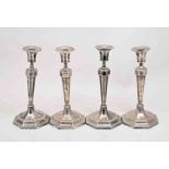 A set of four George III style silver table candlesticks, by Hawksworth Ayre & Co.