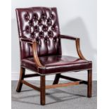 A George III style mahogany Gainsborough chair, buttoned maroon leather upholstery,