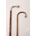 An Edwardian bamboo walking stick, with a silver handle, London 1908,