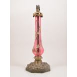 A gilt metal and ruby glass lamp base, slender pear shape column,