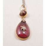 A Victorian teardrop shape pendant, with pink cabochon cut stone, in a closed back setting,