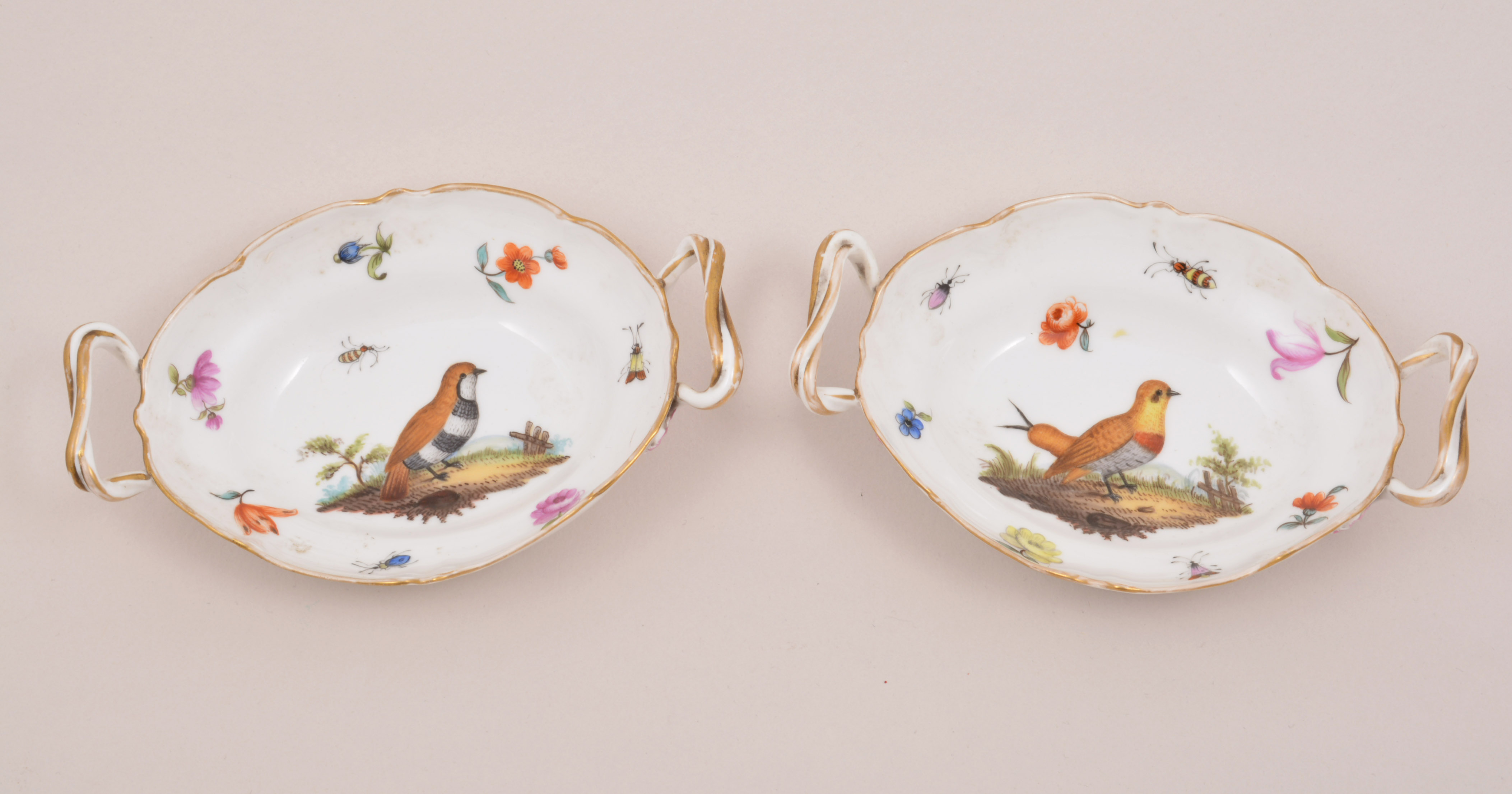 A pair of Berlin oval sweet meat dishes, KPM, probably late 19th Century, each painted with a bird,