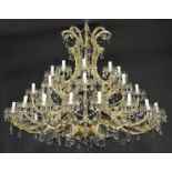 An impressive thirty-six light cut glass chandelier,  scrolled branches issuing from nine S-scrolls,